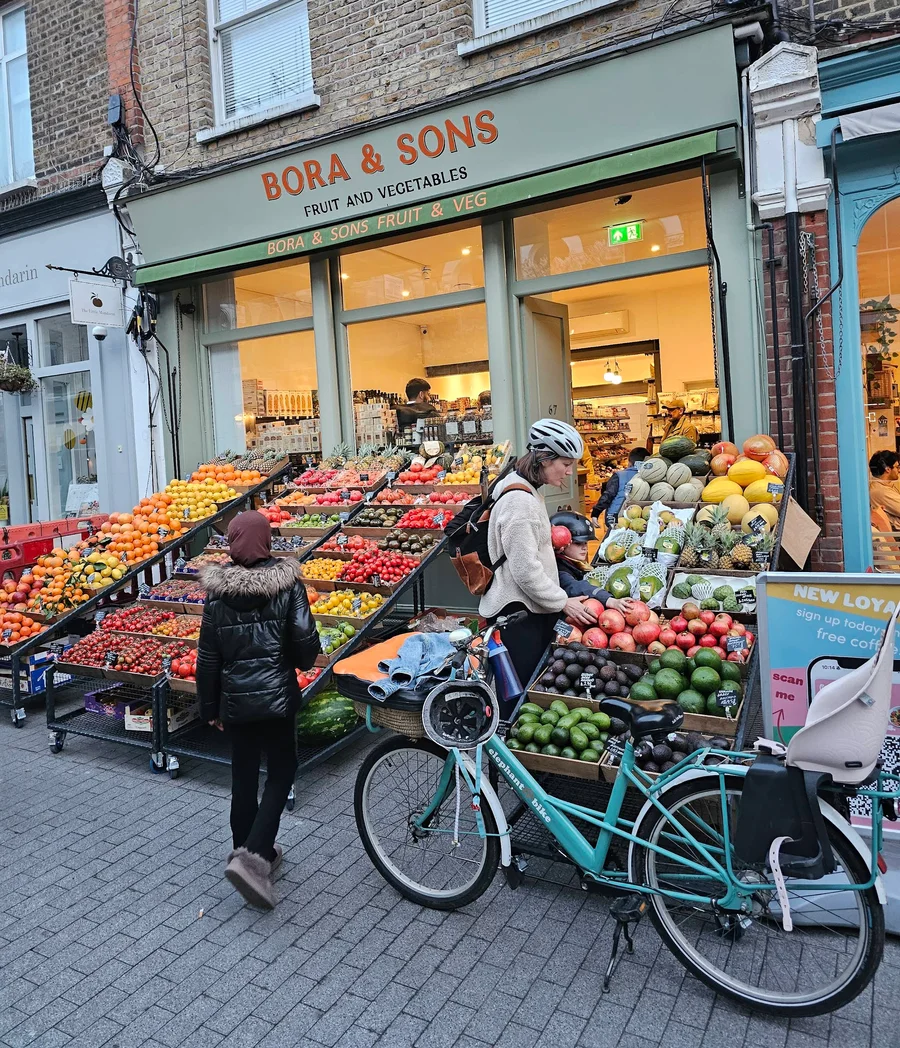 The Bora & Sons shopfront on Orford Road, Walthamstow — colourful produce displays spilling onto the pavement under the green and orange sign